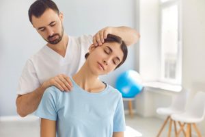 Physical therapist fixing patient's neck